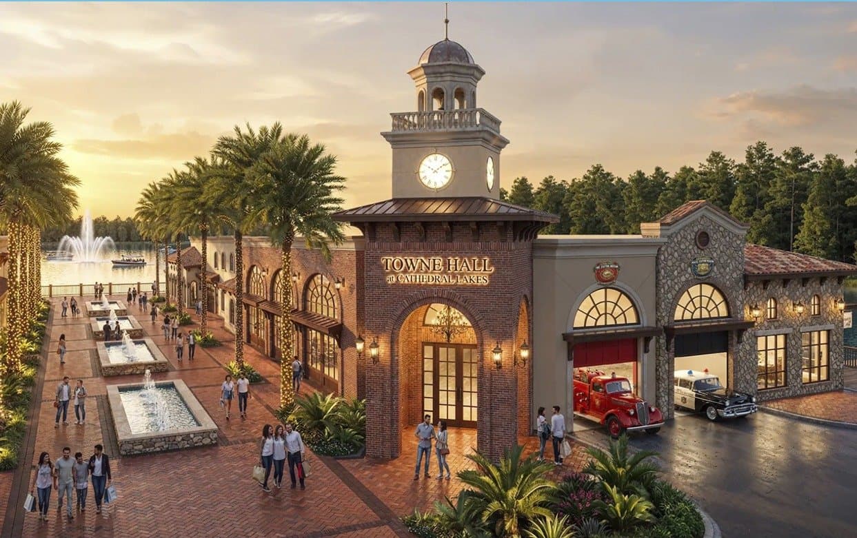 Cathedral Towne Hall with clock tower above a plaza with fountains